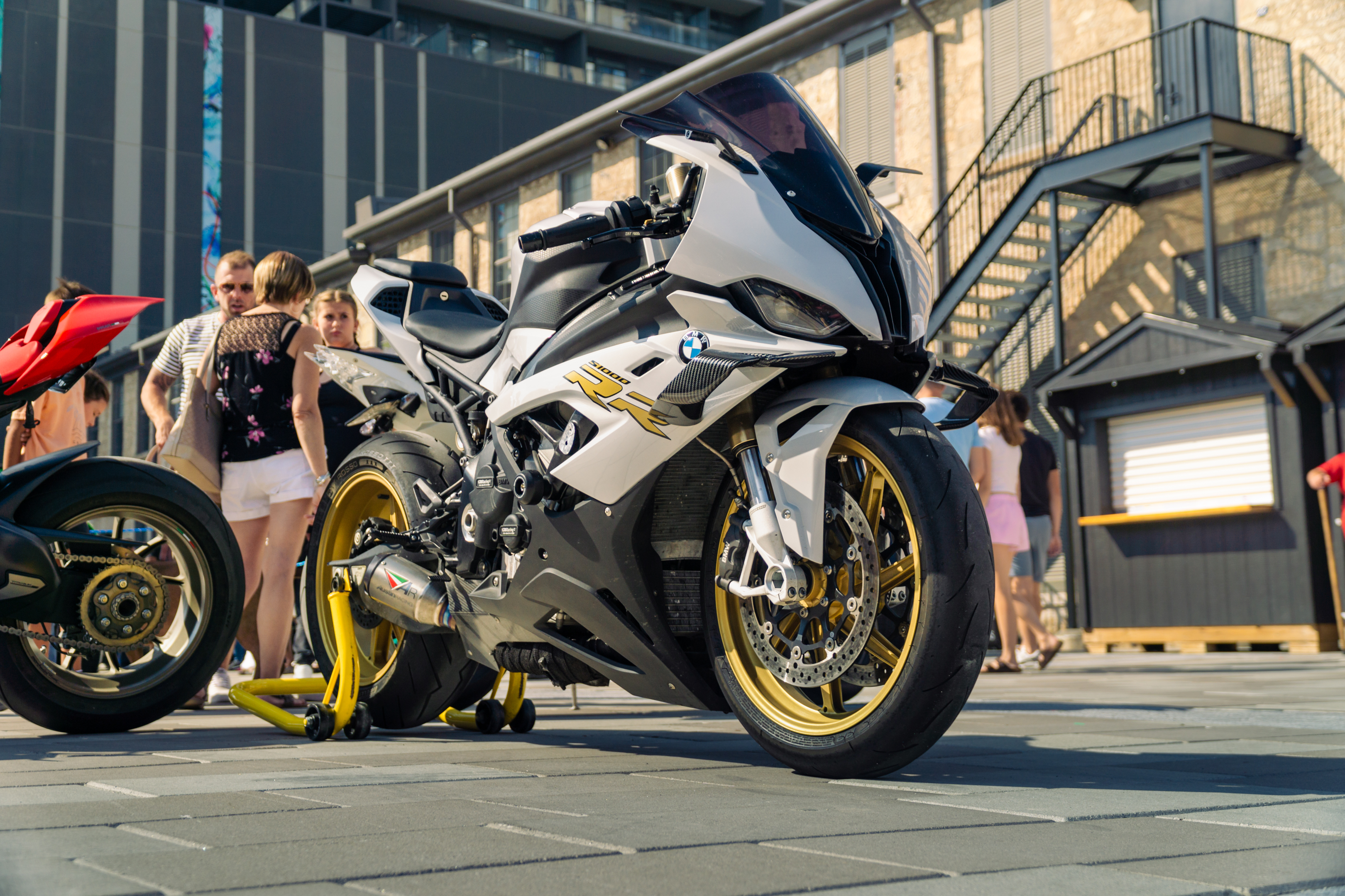 A white BMW motorcycle displayed at the event